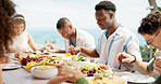 People, eating or dining with food at resort for lunch, meal or get together by table. Group, hungry friends or event with hospitality or accomodation for feast, holiday party or weekend vacation