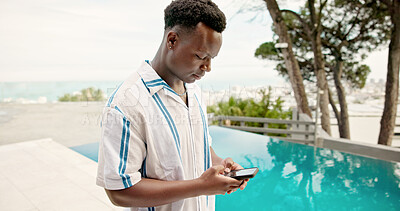 Buy stock photo Pool, travel and black man with smartphone, internet and weekend break with hotel. Person, summer holiday and guy with cellphone, tourism and social media with connection, luxury resort or Zanzibar