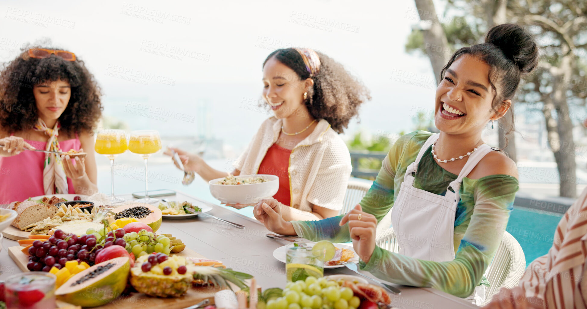 Buy stock photo Happy people, laughing and eating with food at resort for lunch, meal or get together by dining table. Group, hungry friends or event with smile or hospitality for feast, holiday party or fun weekend