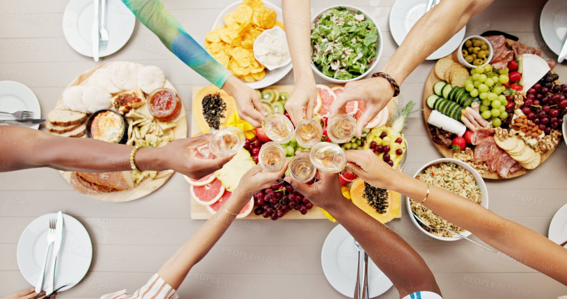 Buy stock photo Above, hands and friends cheers with champagne for birthday party, social gathering and celebration. People, toast and alcohol with healthy food, holiday event and group reunion for bonding together
