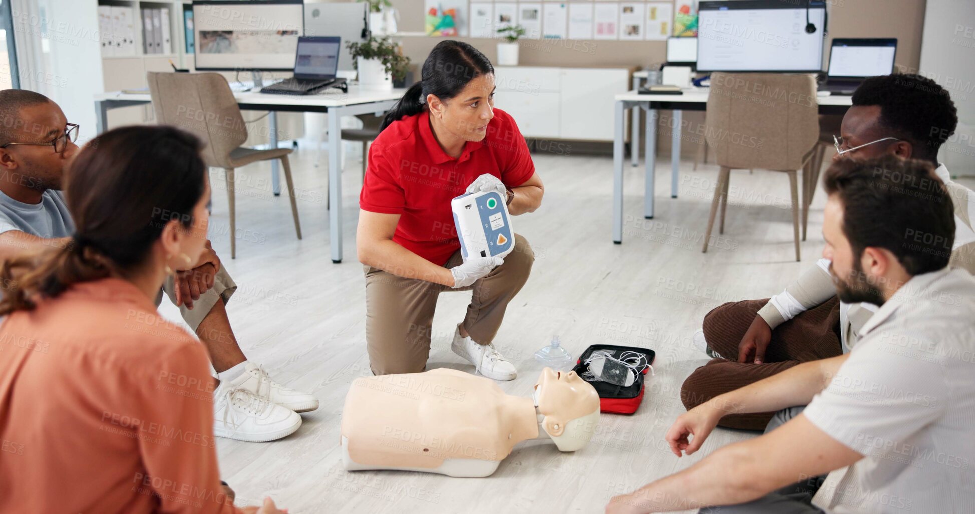 Buy stock photo Mannequin, cpr and training with people and defibrillator for first aid workshop, cardiac arrest rescue or safety protocol. Healthcare class, medical simulation and heart rhythm with paramedic course