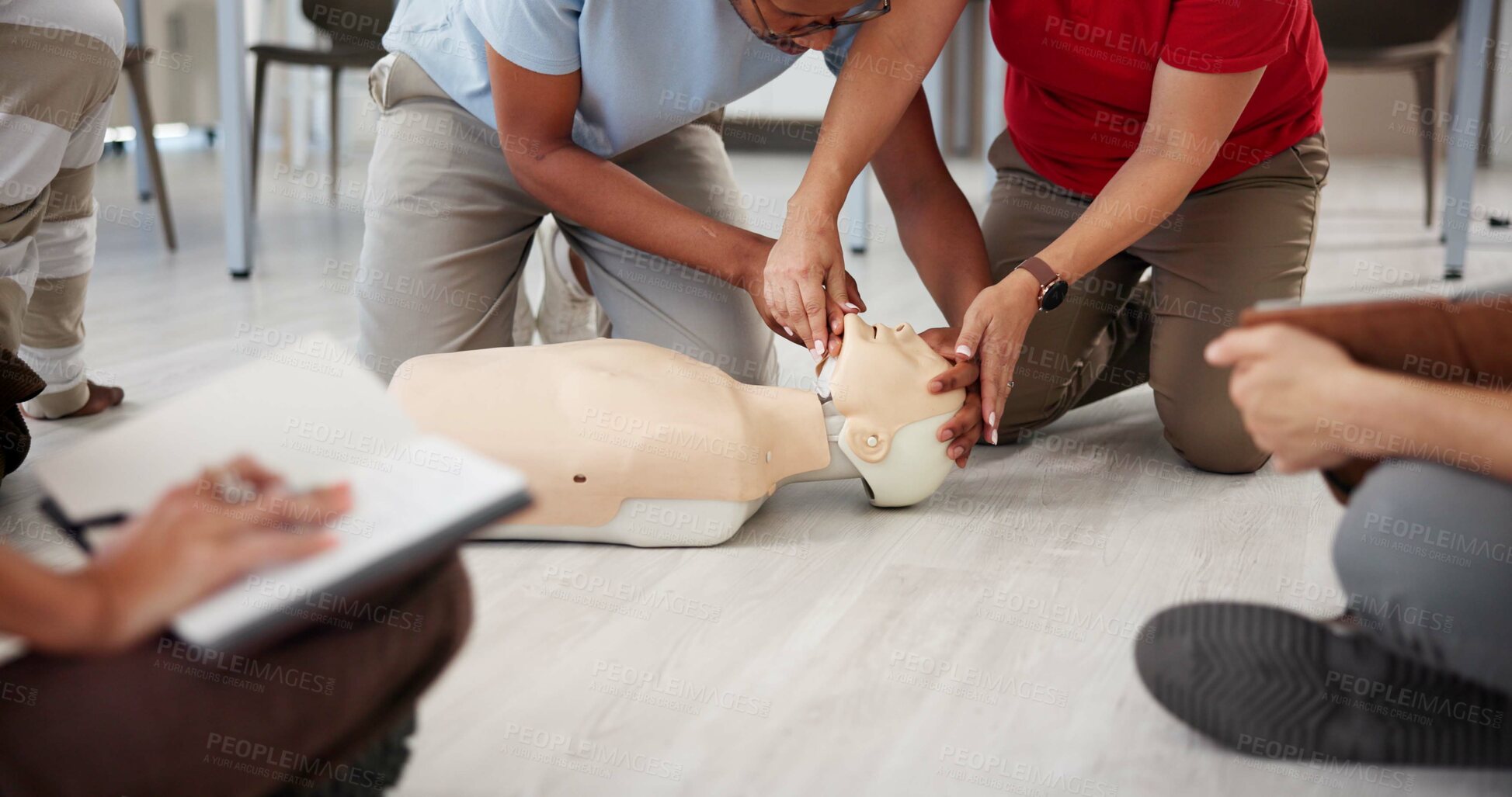Buy stock photo People, mannequin and hands in office for first aid, CPR workshop and choking prevention lesson. Team, emergency practice and dummy in agency for open airways procedure, notes and employee engagement