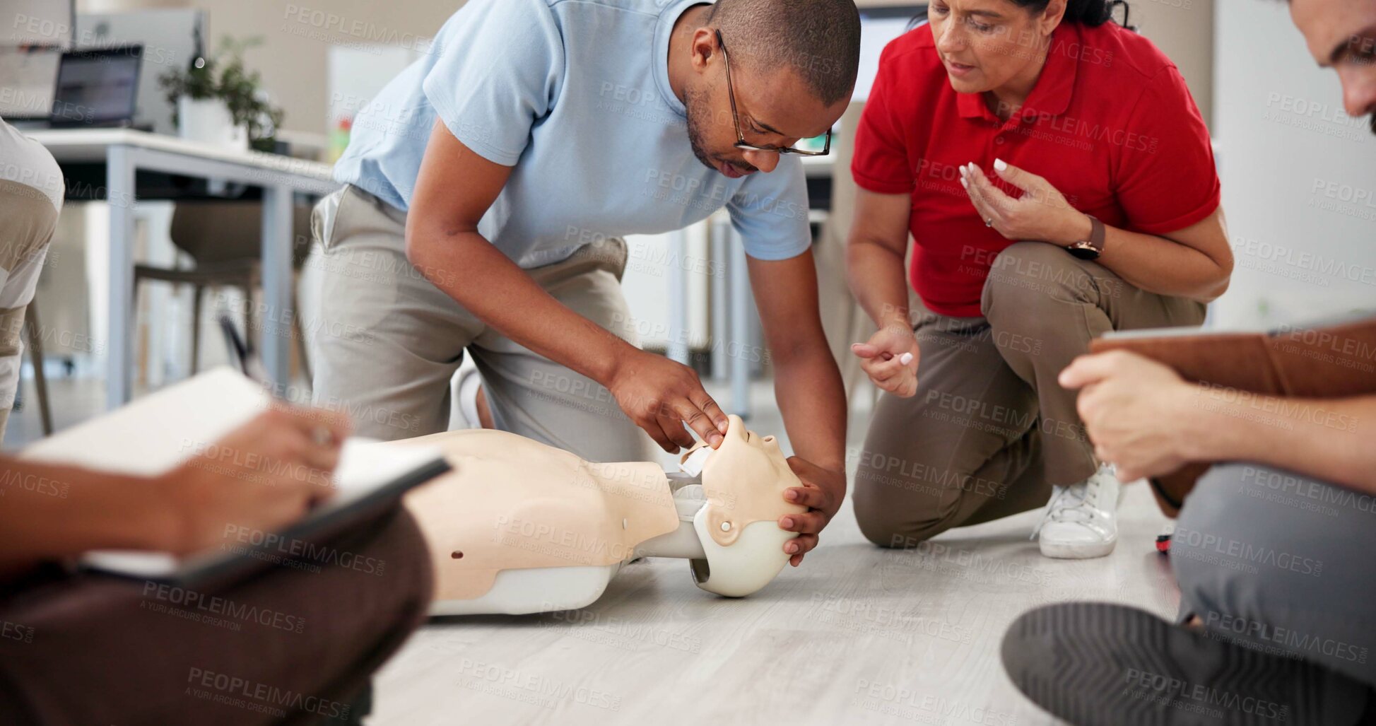 Buy stock photo People, mannequin and training in office for first aid, CPR workshop or choking prevention lesson. Team, emergency practice or dummy in agency for open airways procedure, notes or employee engagement