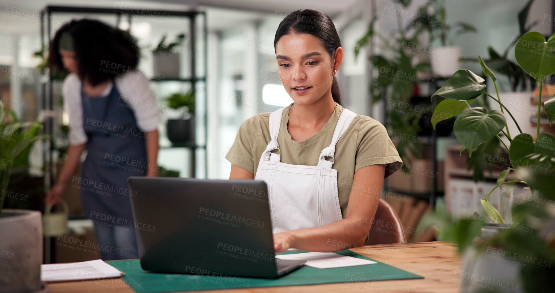 Buy stock photo Laptop, online order and typing with woman in flower shop for sale of floral arrangements. Computer, inventory and plant nursery with florist at desk in office of small business for ecommerce