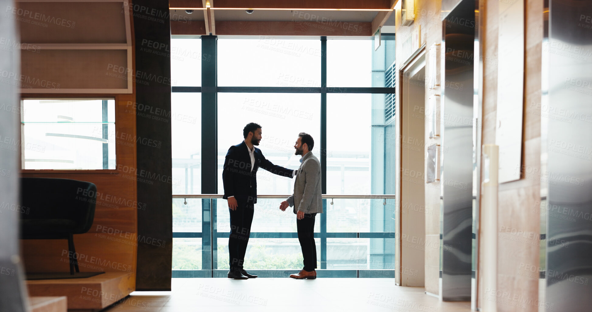 Buy stock photo Collaboration, conversation and meeting with business people at window in office for partnership. Discussion, planning and teamwork with employee men in professional workplace for planning or welcome