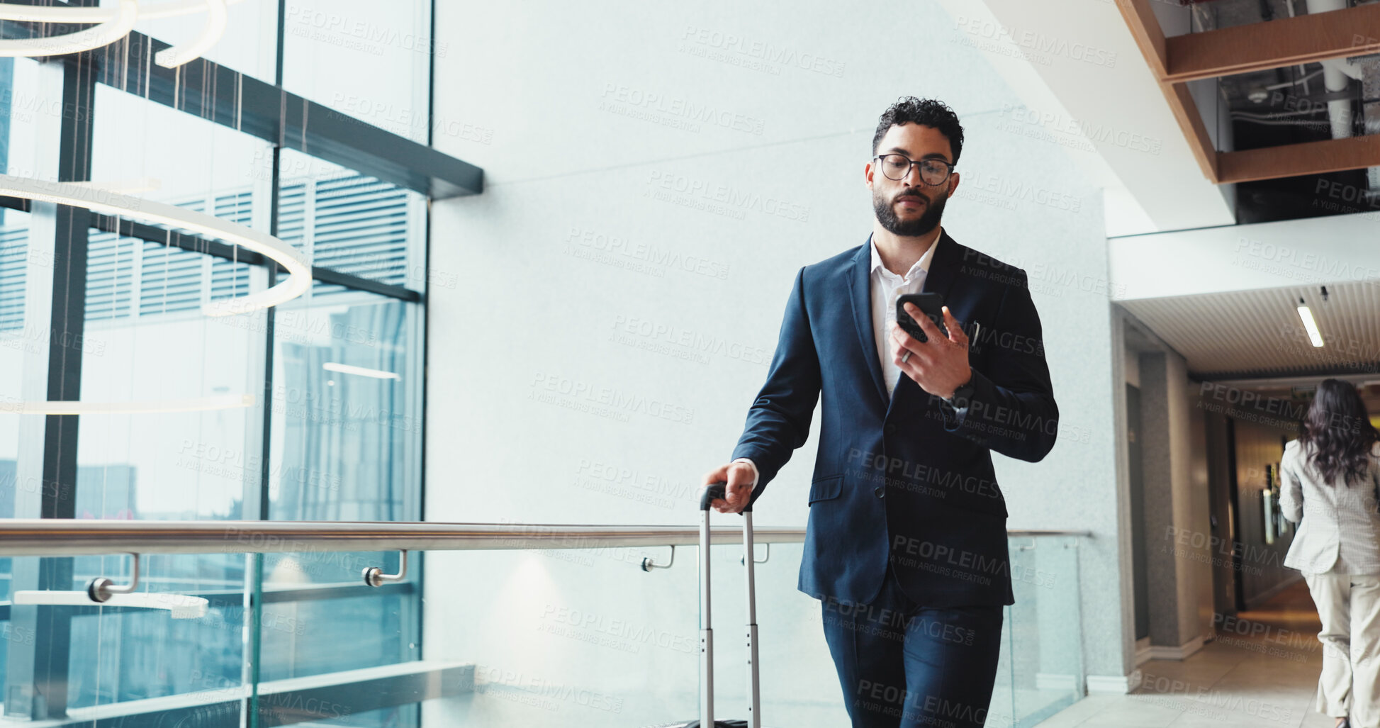 Buy stock photo Phone, suitcase and travel with business man in airport, checking flight schedule for check in. App, luggage and social media with employee person walking in corridor for arrival or departure