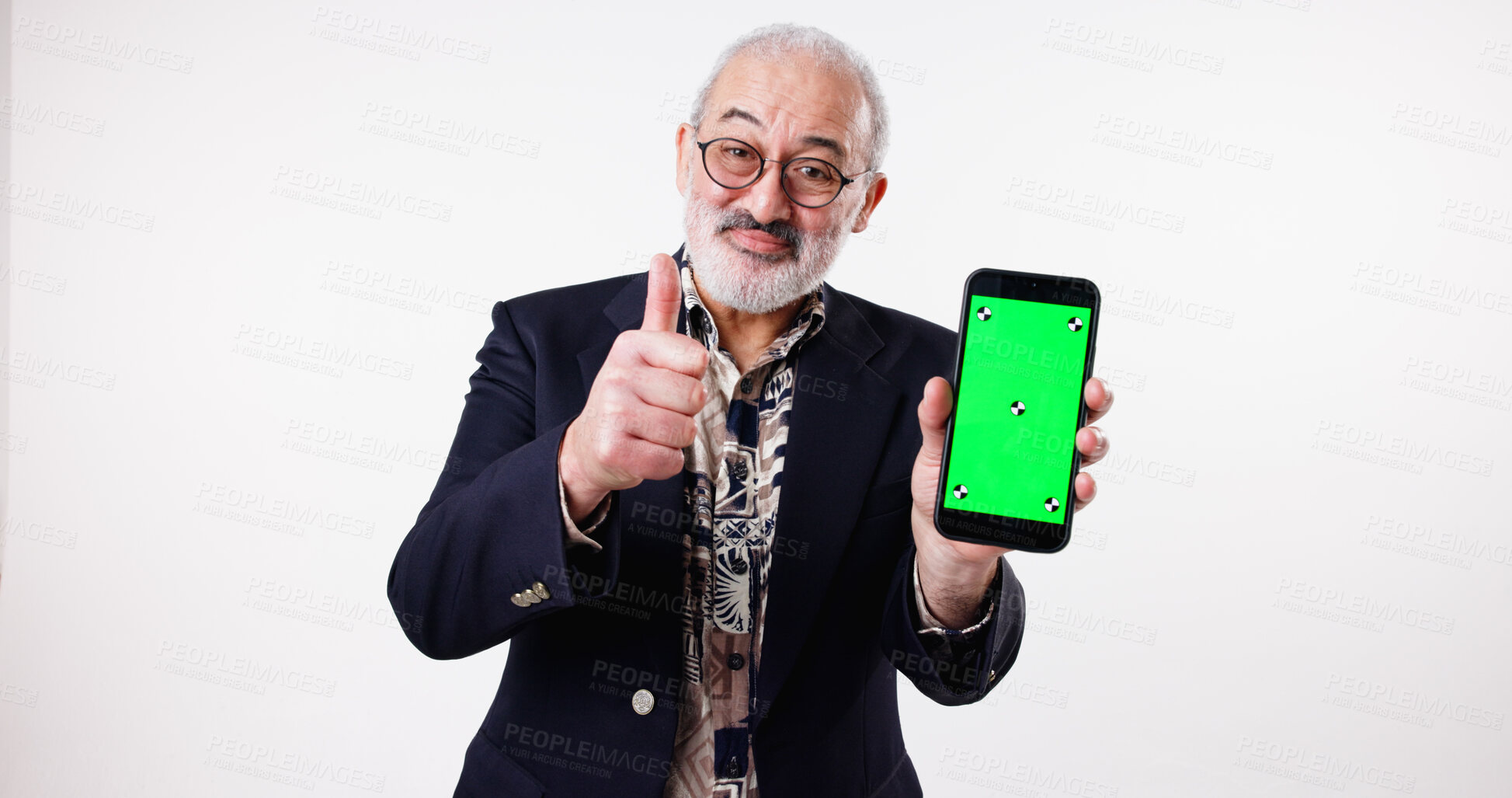 Buy stock photo Thumbs up, green screen and mature man with smartphone, space and opinion for presentation of mobile. White background, studio and advertising of tracking markers, portrait or yes for display of tech