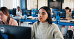 Girl, student and listening with computer in classroom for lecture, education or learning at IT university. Female person, learner or studying with technology for lesson, presentation or tech course