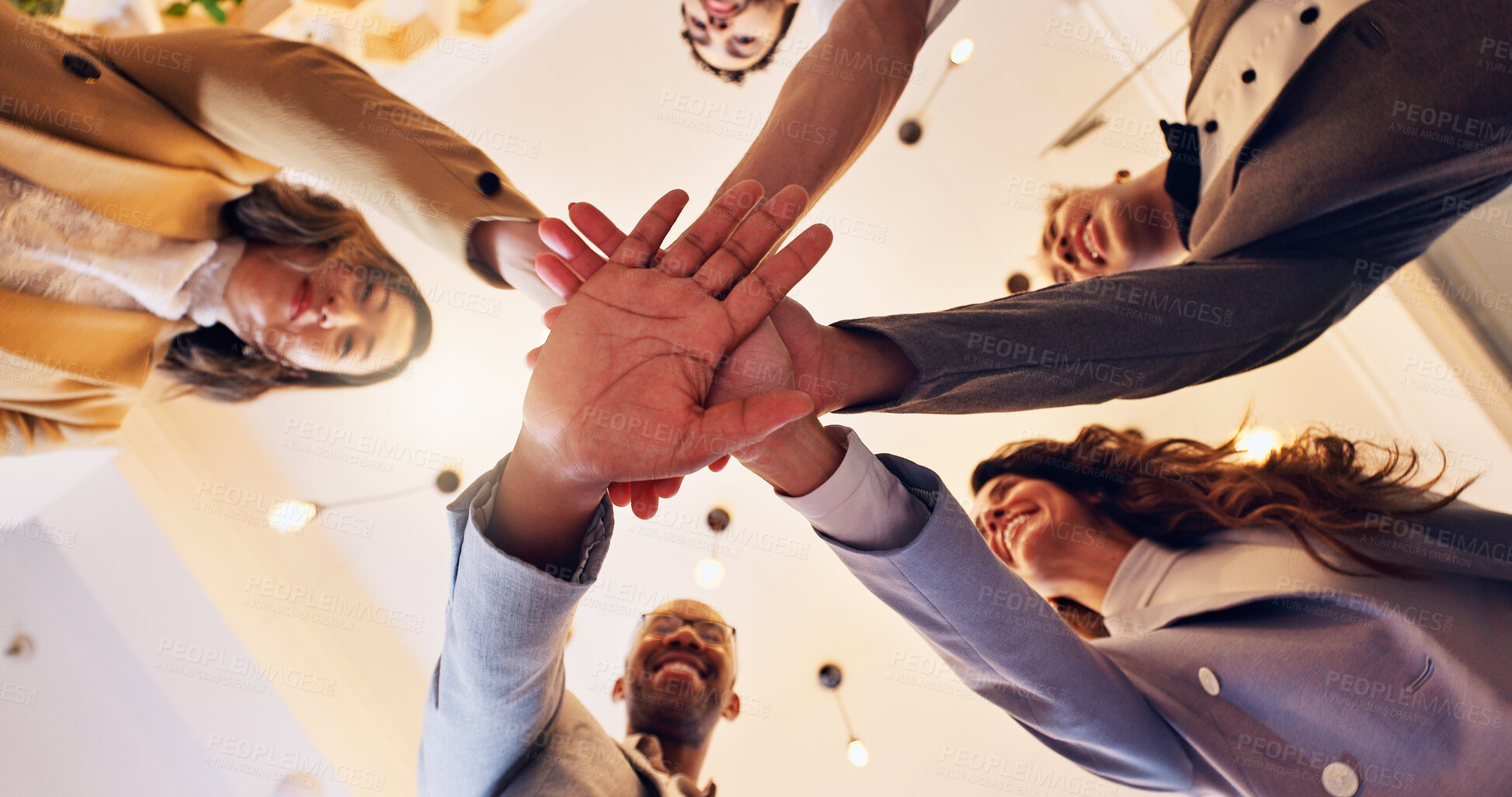 Buy stock photo Happy, business people and meeting with hands together below for unity, motivation or teamwork at office. Low angle, group or employees piling with smile or trust for mission, synergy or solidarity