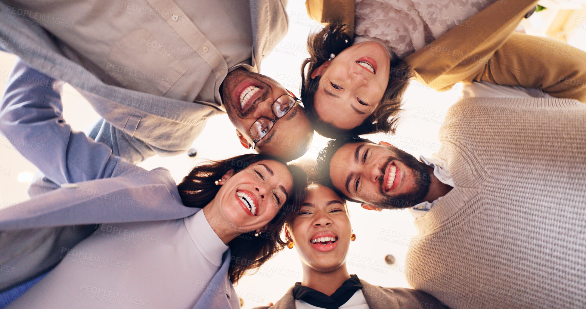 Buy stock photo Happy group, portrait and huddle with team below for motivation, unity or mission together. Low angle, faces or excited people with smile, hug or support for community solidarity, trust or synergy