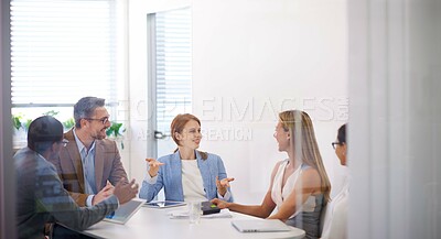 Buy stock photo Shot a team of colleagues having an office meeting