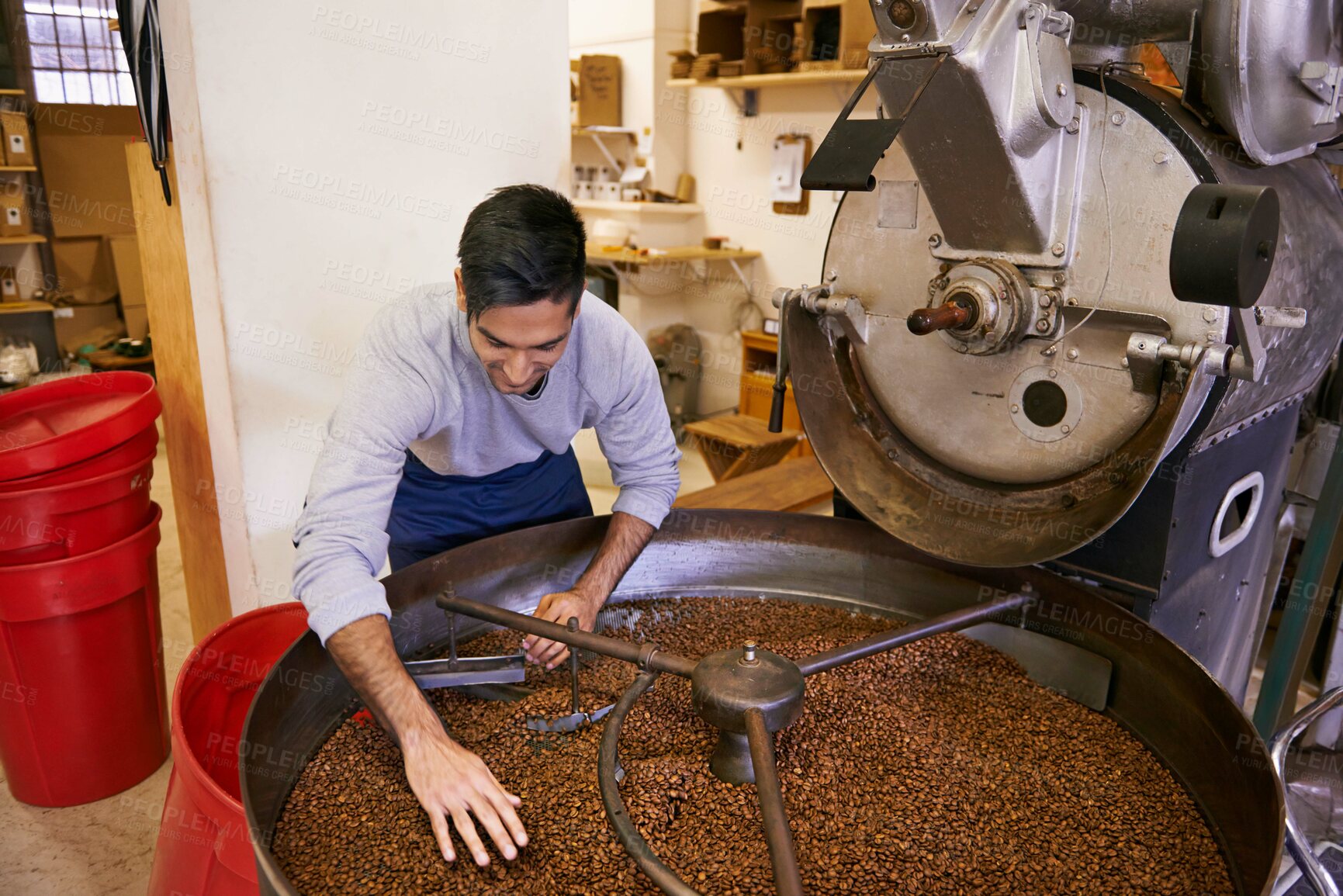 Buy stock photo Coffee beans, blend and man with machine for roasting with small business, production and quality control. Entrepreneur, barista or worker with grain at cafe, sustainable startup and espresso process
