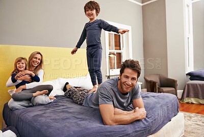 Buy stock photo Home, parents and kids fun on bed with love, support and bonding together with a smile. Happy, family and children with mom in the morning in the bedroom play with sibling in a house with parenting