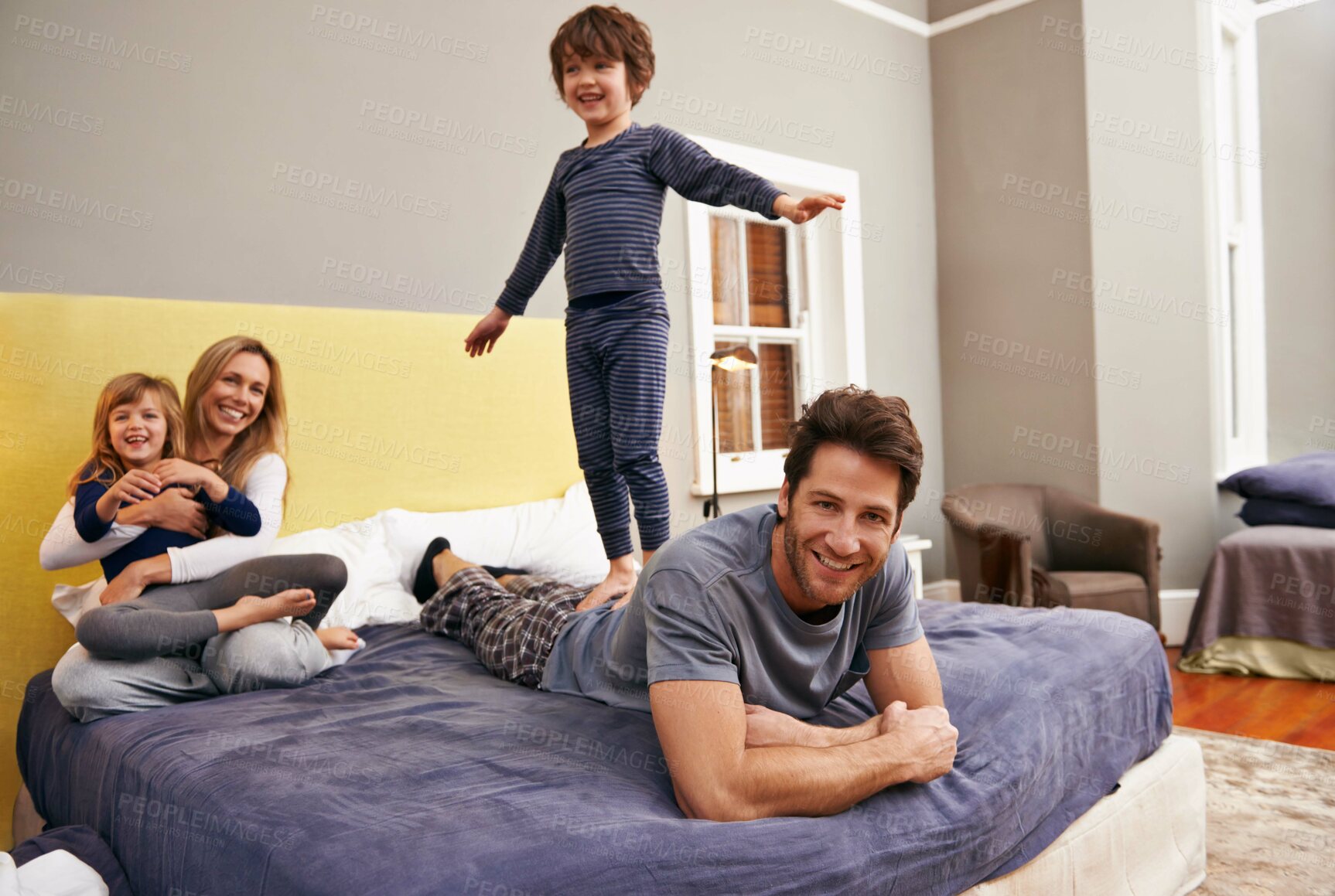 Buy stock photo Home, parents and kids fun on bed with love, support and bonding together with a smile. Happy, family and children with mom in the morning in the bedroom play with sibling in a house with parenting