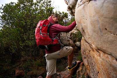 Buy stock photo Rock climbing, hiking and man on mountain, nature and environment for outdoor adventure. Male person, athlete or sport in environment for exercise, fitness or health with backpack by plants in forest
