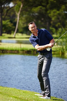 Buy stock photo Mature man, golf course and sport on grass for fitness with green field, water and swinging club. Male golfer, equipment and training for sports with sportswear, workout and lawn for health by pond