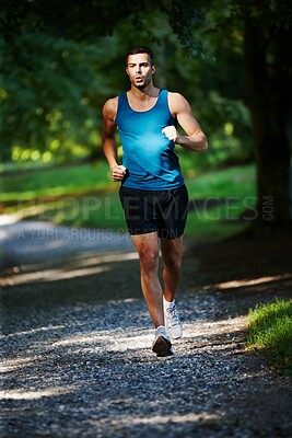 Buy stock photo Man, fit and running in outdoor for exercise, health and wellness in nature for workout or fitness. Male athlete, training and cardio with endurance, muscles and strength for healthy living or gym