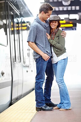 Buy stock photo Hug, platform and love with couple at train station. for holiday, explore and journey together. Metro, public transportation and transit with people at subway for support, adventure and date