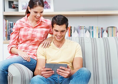 Buy stock photo Couple, home and smile with tablet on sofa for social media, networking and entertainment. People, couch and living room on internet or online with streaming platform for videos, fun and memes