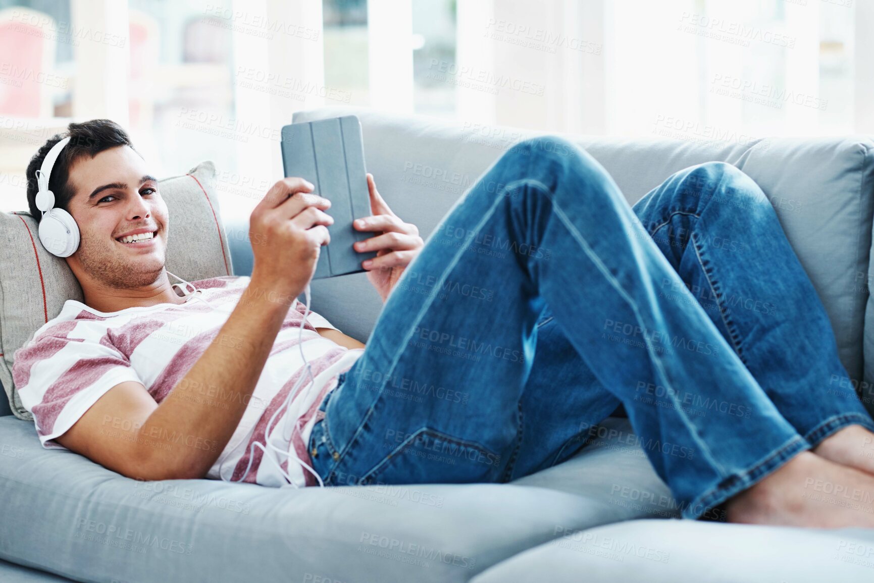 Buy stock photo Sofa, headphones and portrait of man with tablet for online video, subscription and watching movie. Happy, relax and male person with digital technology at home for network, connectivity or streaming