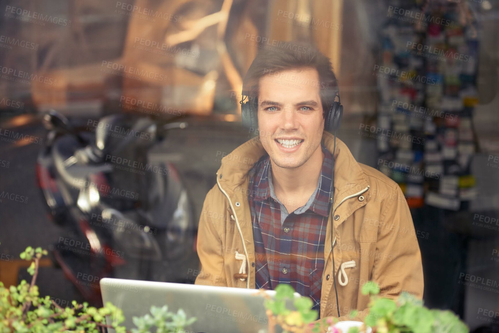Buy stock photo Man, portrait and laptop with headphones in coffee shop for remote work, music or smile in morning. Person, journalist or writer with computer, happy or online streaming by window for article in cafe