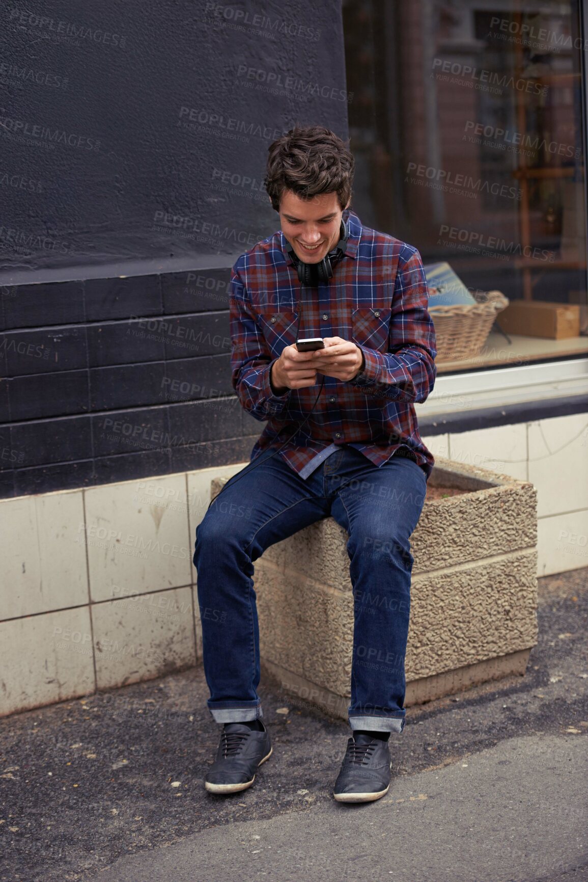 Buy stock photo Man, reading and texting in city with phone, chat and happy for notification with mobile app for connection. Person, smartphone and click with contact, smile and scroll with social media in street