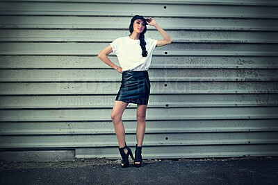 Buy stock photo Garage, travel and woman in city with fashion, cap or gender neutral clothes for upcycling, street style or inspiration. Streetwear, hat or gen z girl in New York for y2k, sale or thrifting choice