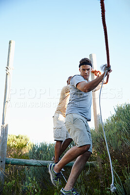 Buy stock photo Athlete, men and walking on rope outdoor for physical strength, training and body balance. Active, people and climbing for obstacle course, survival test and exercise of workout challenge at bootcamp