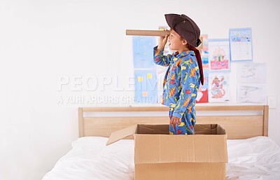 Buy stock photo Child, box and pirate hat with spyglasses on bed in home for play, adventure and game as creativity. Boy, cardboard and tricorn with telescope in bedroom for fun, journey and activity as imagination