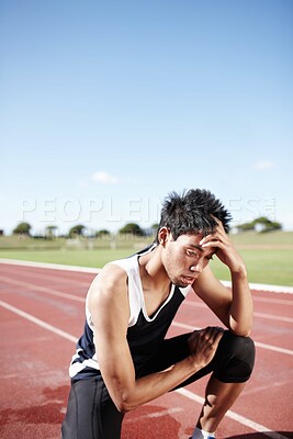 Buy stock photo Tired, man and runner on track for running with training for race, marathon or competition. Exhausted, break and male long distance athlete with conditioning, challenge and cardio workout at stadium.