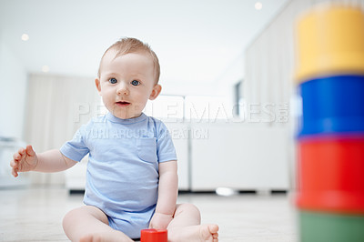 Buy stock photo Baby, toys and building games in home, curious and blocks for creative education on lounge floor. Boy, infant and learning motor skills and independence in portrait, shapes and playing for mobility