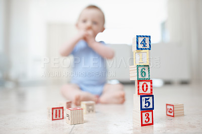 Buy stock photo Baby child, toys and building blocks in home, curious and creative education on living room floor. Boy, kid and learning motor skills and independence in play, wooden shapes and brain development