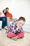 House, unhappy and child in living room, portrait and upset for punishment by parents, bored and lonely. Home, disappointed and girl in lounge with family, discipline and grounded in apartment or USA