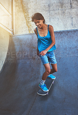 Buy stock photo Skateboard, portrait and girl on ramp for skating stunt, practice and energy in city in skate park. Woman, skater and person with smile on concrete for outdoor talent, skill competition and hobby