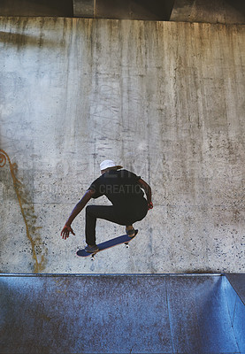 Buy stock photo Jump, skateboard and balance with man at park for urban, extreme sports and trick flips. Street league, culture and fitness with person and skating for grind in city with youth, energy and hobby
