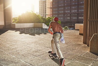 Buy stock photo Skateboard, culture and back of man in city for fitness, practice or energy in New York. Active, skater or male person skating on concrete in urban town for outdoor talent, skill competition or hobby