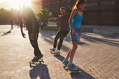 Buy stock photo Friends, skateboard group and people in street, city or outdoors for fun practice. Exercise, fitness and extreme sports with training and skaters bonding together on urban road for downtown workout