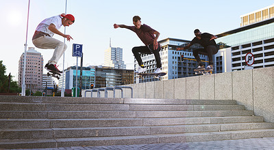 Buy stock photo Friends, skateboard group and stunt jump in street, city or outdoors for practice. Men, steps and exercise trick with training, skaters and together on urban road for downtown workout and fitness