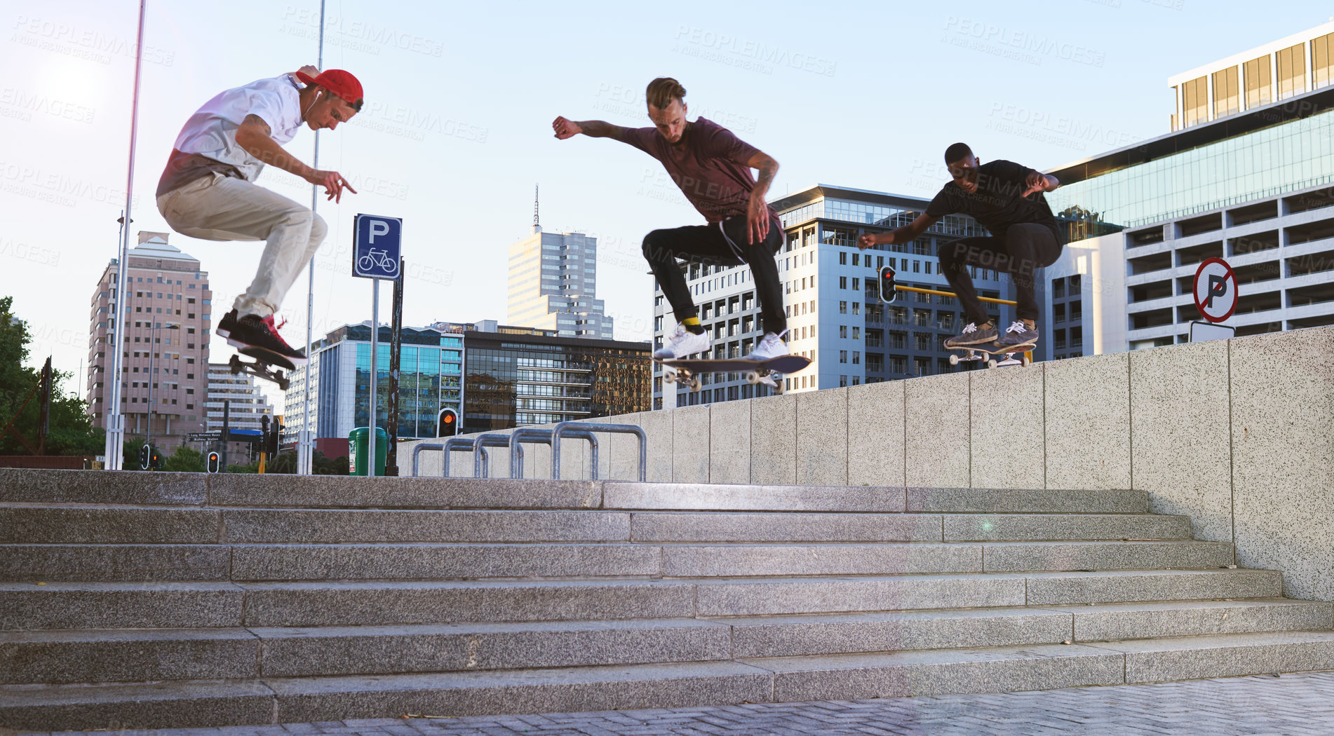 Buy stock photo Friends, skateboard group and stunt jump in street, city or outdoors for practice. Men, steps and exercise trick with training, skaters and together on urban road for downtown workout and fitness