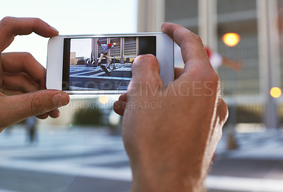 Buy stock photo Person, hands and skateboard with phone screen or camera for jump trick, content creation or vlog in an urban town or city. Closeup, photographer or capture with picture at skate park for flip stunt