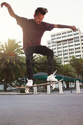 Buy stock photo Skateboard, city and man with ollie trick in air for jump stunt, practice and energy in New York. Rooftop, skater and person flying for flip on concrete for outdoor talent, skill competition or hobby