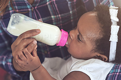 Buy stock photo Hands, milk and bottle for feeding baby girl in home with mom, bonding and nutrition for growth. Infant, mother and daughter with container for breastmilk, formula and or child care in family house