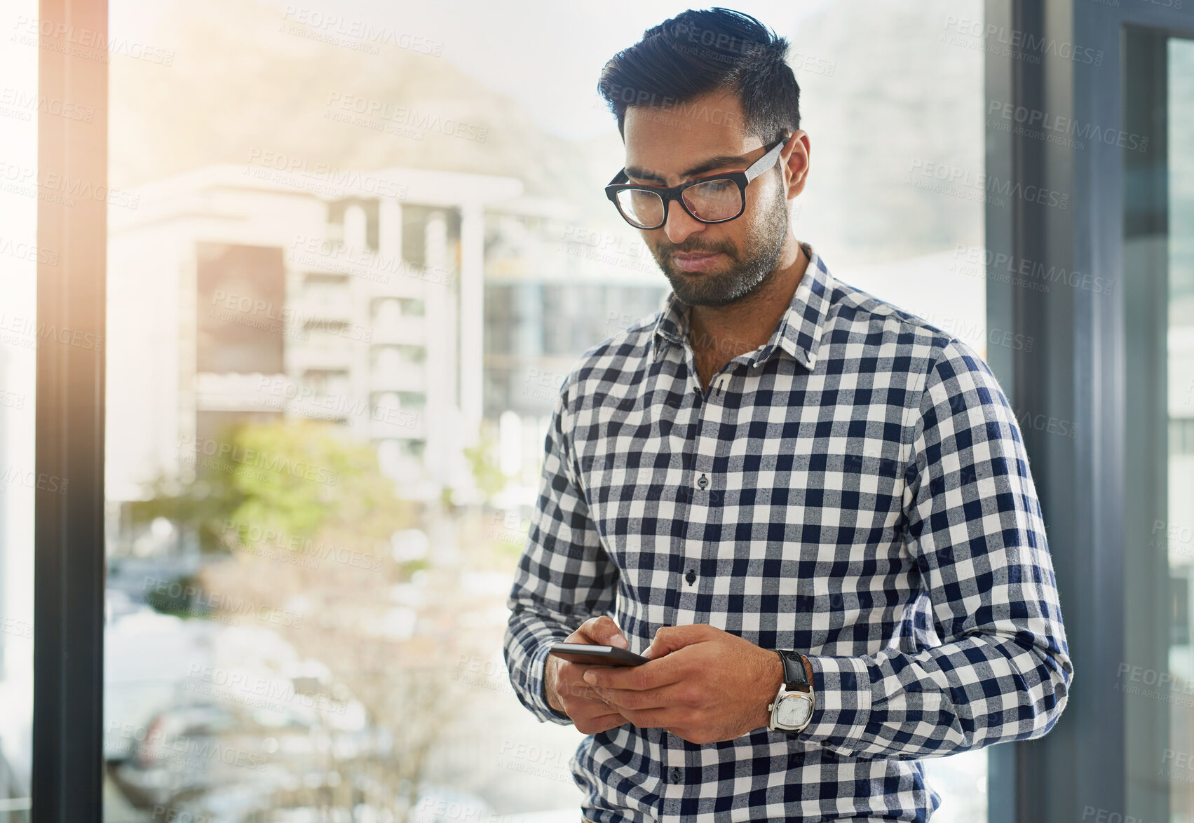 Buy stock photo Businessman, coffee or phone in office for texting or news, email for big idea at window. Male consultant or espresso in workplace with mobile for communication, typing with advice for company