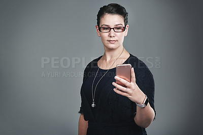 Buy stock photo Business woman, phone and texting in studio for contact, notification or web chat with corporate job by background. Person, smartphone and check email for deal, mobile app or network for social media