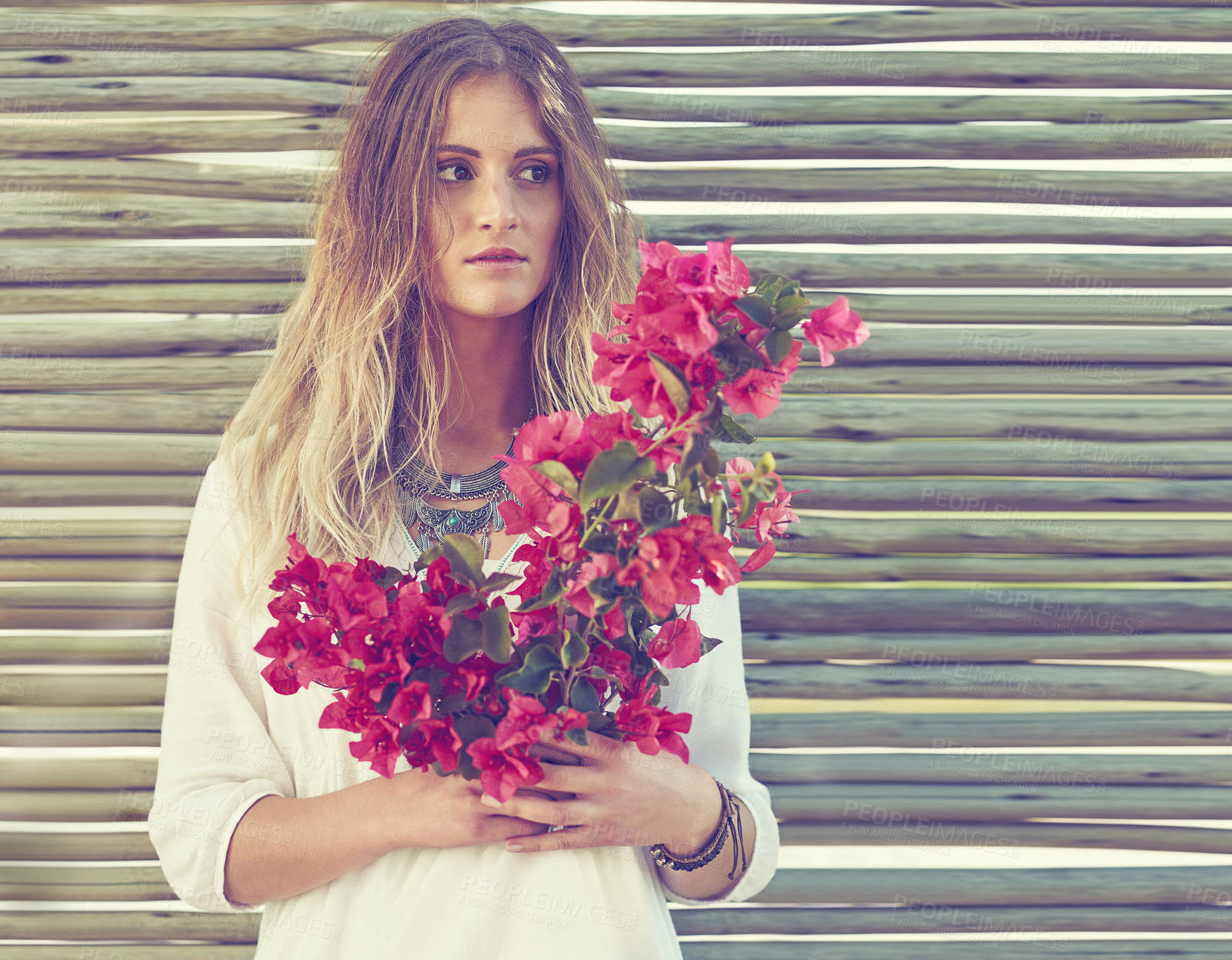 Buy stock photo Bohemian, style and woman with flowers outdoor for sustainable, casual and hipster clothes. Gypsy, blossom and female person with pink bogainvillea floral bouquet in spring with eco friendly fashion.