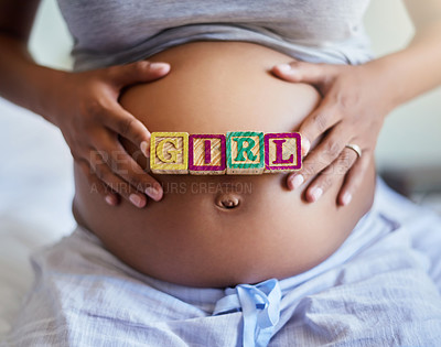 Buy stock photo Hands, pregnant woman and blocks for gender reveal, girl and expect daughter in home. Stomach, pregnancy and future mom with words on body for love, prenatal care and baby announcement in maternity