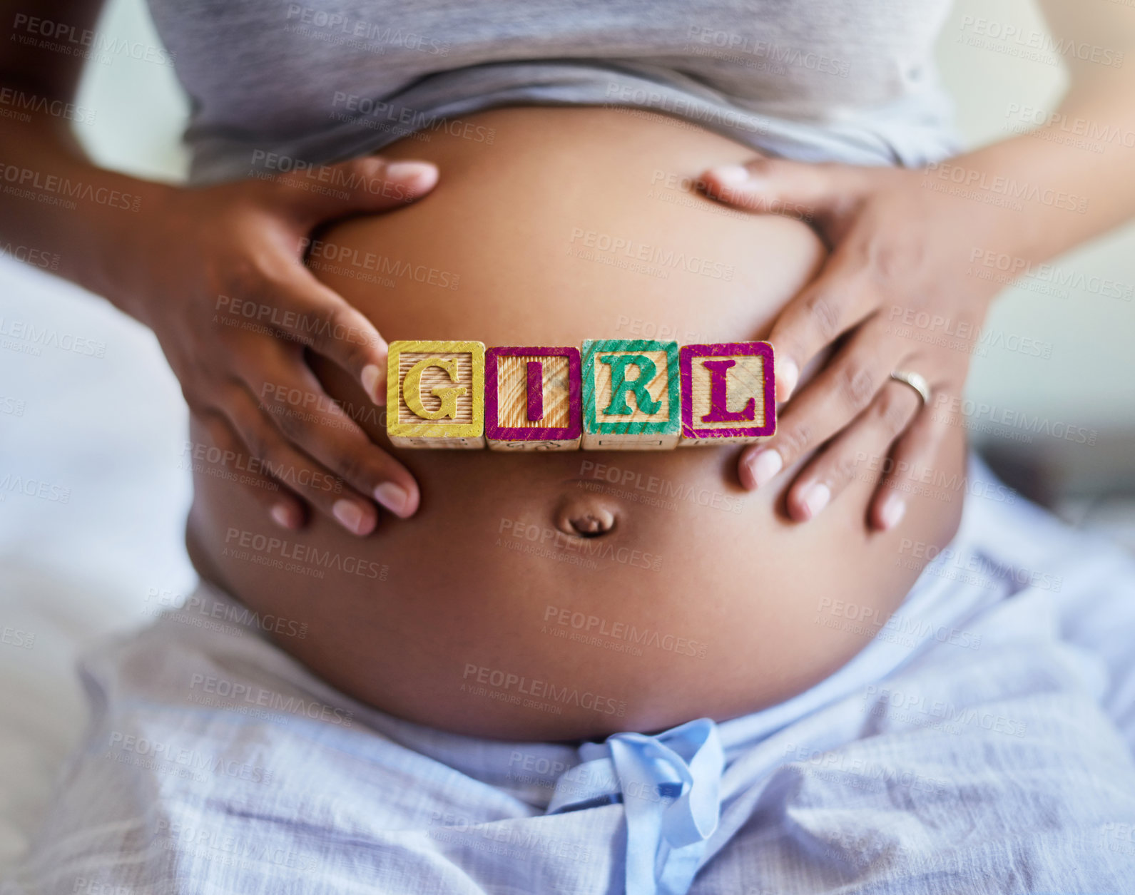Buy stock photo Hands, pregnant woman and blocks for gender reveal, girl and expect daughter in home. Stomach, pregnancy and future mom with words on body for love, prenatal care and baby announcement in maternity