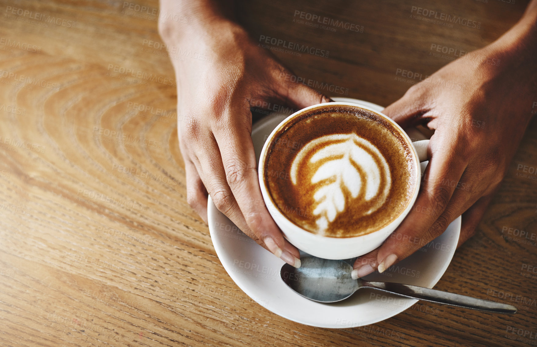 Buy stock photo Hands, latte art and wooden table with customer in coffee shop for hospitality, relax or service. Artistic, beverage and cup with person in cafe or restaurant for morning caffeine drink from above