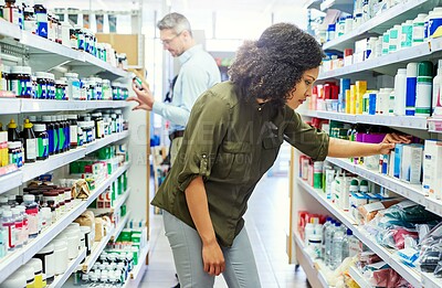 Buy stock photo Pharmacy, wellness shopping and woman with medicine and product in a retail store. Pharmaceutical, drugs and pills with a African female person looking at box for ingredients and information in shop