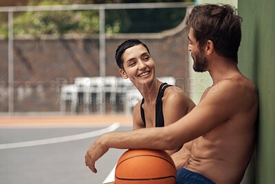 Buy stock photo Basketball, conversation and couple on court, relax and break with wellness, competition and support. Friends, happy people and players with health, training and motivation with advice and sports